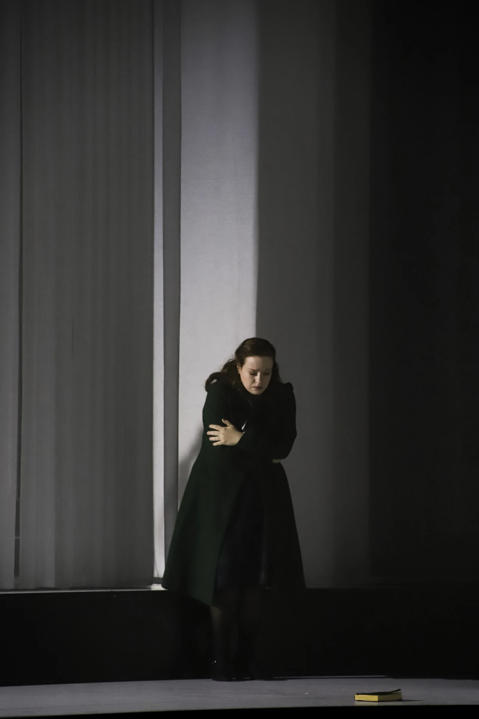 Donata Meyer-Kranixfeld alone in a dark costume in The Turn of the Screw
