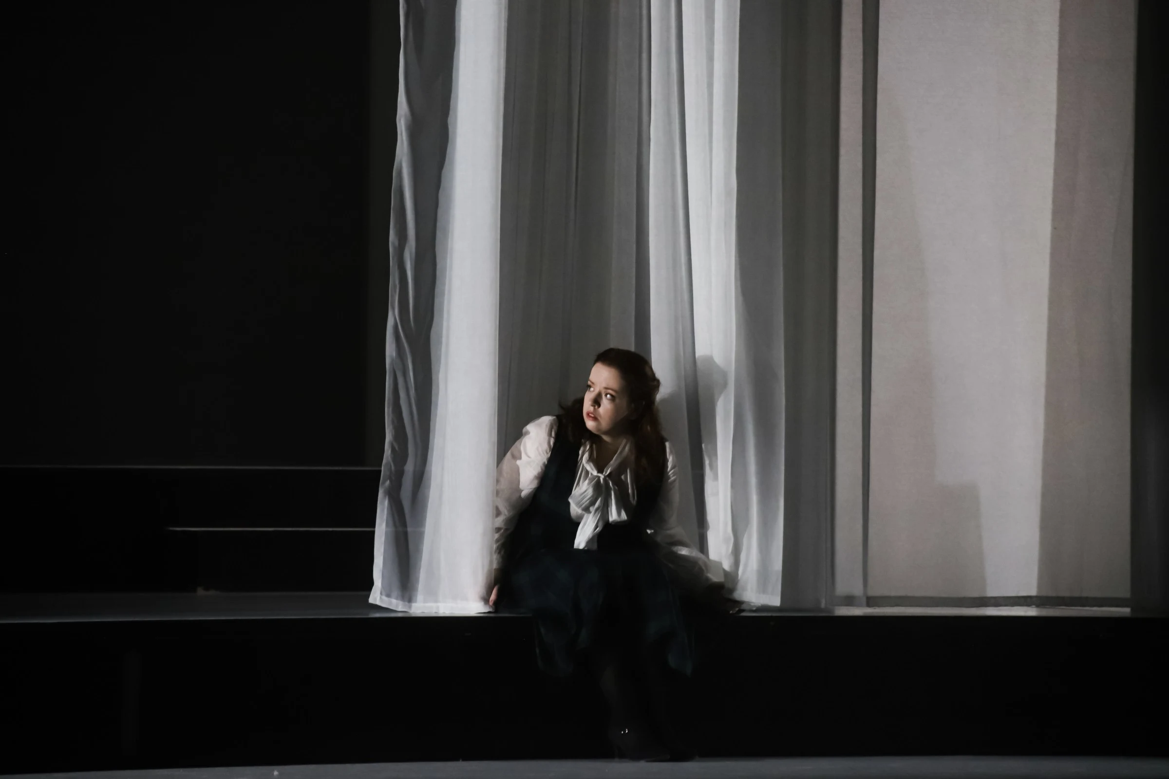 Donata Meyer-Kranixfeld seated beside another performer in The Turn of the Screw