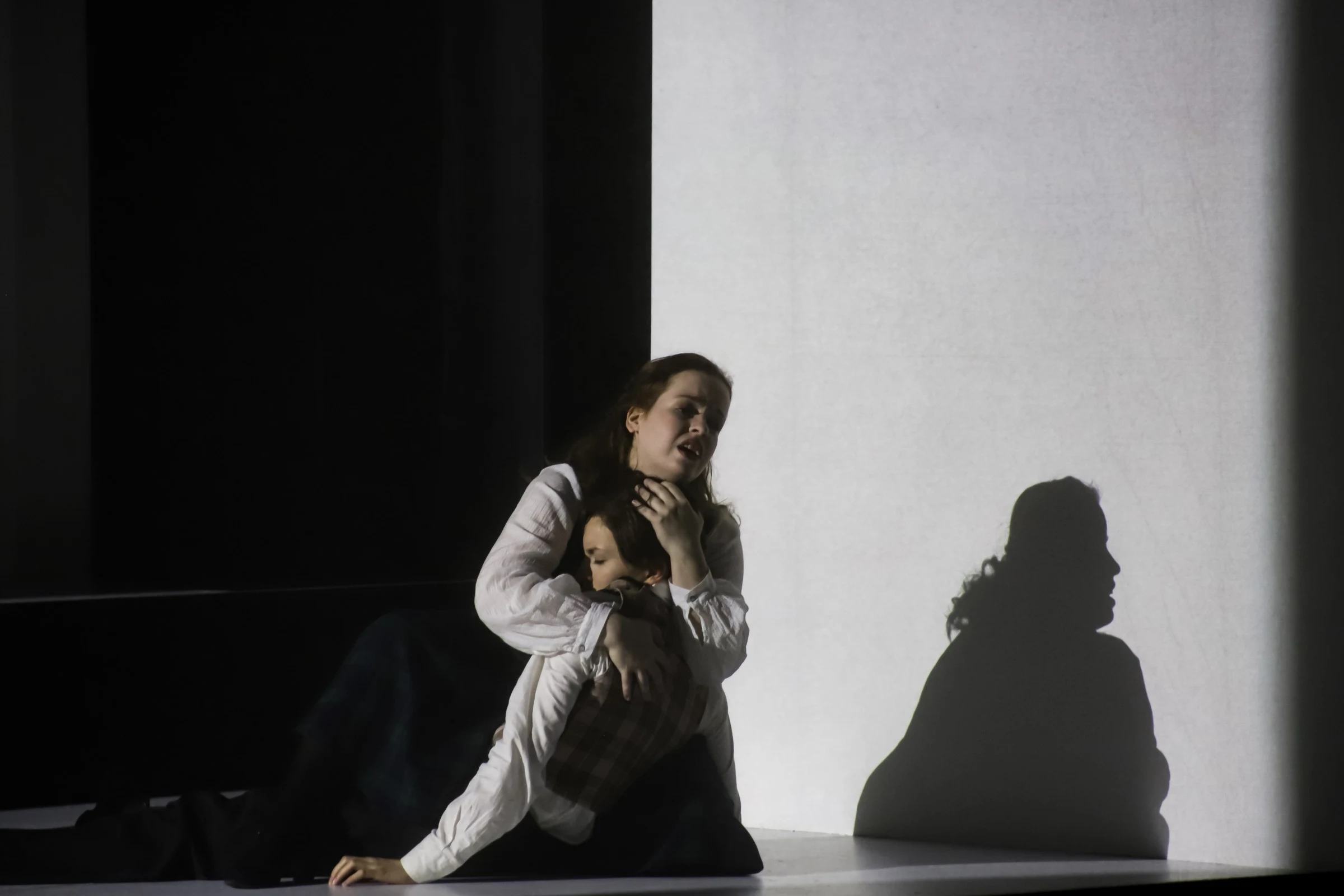 Donata Meyer-Kranixfeld embracing another performer in The Turn of the Screw